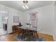 Open-concept dining area with glass table, hardwood floors, and a view to the kitchen at 39 S Grant St, Denver, CO 80209