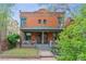 Charming brick home with inviting front porch, manicured lawn, and landscaped garden beds at 39 S Grant St, Denver, CO 80209