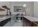 Modern kitchen with stainless steel appliances, gray cabinetry, and an eat-in island at 39 S Grant St, Denver, CO 80209