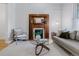 Cozy living room featuring a decorative fireplace, hardwood floors, and ample seating at 39 S Grant St, Denver, CO 80209