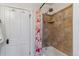 Bathtub with decorative tile surround and bright floral curtain at 39 S Grant St, Denver, CO 80209