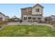 Expansive backyard with a well-maintained lawn, patio area, and mature landscaping at 17448 E 103Rd Pl, Commerce City, CO 80022