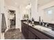 Contemporary bathroom featuring dual sinks with granite countertops and ample storage space at 17448 E 103Rd Pl, Commerce City, CO 80022
