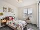 Bright bedroom with a floral themed bed and playful decor at 17448 E 103Rd Pl, Commerce City, CO 80022