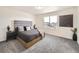 Calm bedroom showcasing a plush bed with a gray headboard and neutral decor at 17448 E 103Rd Pl, Commerce City, CO 80022