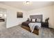 Spacious bedroom featuring plush gray carpeting, a comfortable queen bed and serene decor at 17448 E 103Rd Pl, Commerce City, CO 80022
