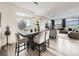 Bright dining area with modern lighting, stylish chairs, and textured accent wall at 17448 E 103Rd Pl, Commerce City, CO 80022