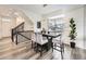 Dining area showcasing modern lighting, stairs, and neutral color palette at 17448 E 103Rd Pl, Commerce City, CO 80022