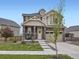 Beautiful two-story home with stone accents, covered porch, and a two-car garage at 17448 E 103Rd Pl, Commerce City, CO 80022