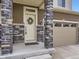 Close-up of a front door with stone pillars and a decorative wreath at 17448 E 103Rd Pl, Commerce City, CO 80022