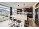 Open kitchen featuring a large island with seating, modern appliances, and natural light at 17448 E 103Rd Pl, Commerce City, CO 80022