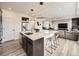 Spacious kitchen island with barstool seating overlooks open concept living space at 17448 E 103Rd Pl, Commerce City, CO 80022