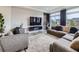 Stylish living room featuring textured wall, modern furniture, and a large window at 17448 E 103Rd Pl, Commerce City, CO 80022