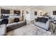 Open-concept living area with hardwood floors, comfortable seating, and ample natural light at 17448 E 103Rd Pl, Commerce City, CO 80022