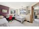 Sunlit bedroom with two beds, a desk, and hardwood trim at 514 Creekside Ct, Golden, CO 80403