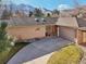 Charming ranch-style home featuring a brick and siding exterior, a curved driveway, and mountain views at 514 Creekside Ct, Golden, CO 80403