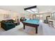 Game room with a pool table, wood-burning stove, and walk-out access to the patio at 514 Creekside Ct, Golden, CO 80403
