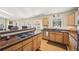 Open concept kitchen with wood cabinets, breakfast bar, granite countertops, and stainless steel dishwasher at 514 Creekside Ct, Golden, CO 80403