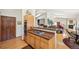 Open concept kitchen with wood cabinets, breakfast bar, granite countertops, stainless appliances, and wood floors at 514 Creekside Ct, Golden, CO 80403