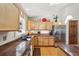 Bright kitchen featuring honey-toned cabinets, granite countertops, stainless appliances, and hardwood flooring under a skylight at 514 Creekside Ct, Golden, CO 80403