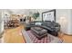 Inviting living area with hardwood floors leading to an open kitchen, comfortable seating, and stylish decor at 514 Creekside Ct, Golden, CO 80403
