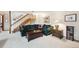 Living room with a green couch, stairs, and white walls at 514 Creekside Ct, Golden, CO 80403