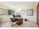 Home office with a large desk, comfortable chairs, and natural light from the window at 514 Creekside Ct, Golden, CO 80403