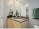 Bathroom features a granite vanity, wood cabinets, large mirror and modern fixtures at 1700 Bassett St # 504, Denver, CO 80202