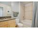 Bathroom features a granite vanity, wood cabinets, large mirror and tiled shower over tub at 1700 Bassett St # 504, Denver, CO 80202