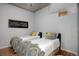 Bright bedroom features two twin beds with designer bedding, wood floors, and modern lighting at 1700 Bassett St # 504, Denver, CO 80202