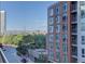 Balcony view features city views, mature trees, and nearby buildings at 1700 Bassett St # 504, Denver, CO 80202