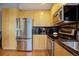 Well-appointed kitchen with stainless steel refrigerator, modern cabinetry, and sleek black backsplash, ideal for cooking at 1700 Bassett St # 504, Denver, CO 80202