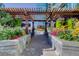 Outdoor lounge area with pergola, flowers, and seating at 1700 Bassett St # 504, Denver, CO 80202