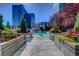 Stunning rooftop pool surrounded by vibrant flowers and planters with city views at 1700 Bassett St # 504, Denver, CO 80202