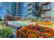 Outdoor pool area with colorful flowers, seating, and modern highrise at 1700 Bassett St # 504, Denver, CO 80202