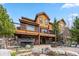 Backyard featuring a hot tub, outdoor seating with a fire pit, and landscaped rocks at 200 Rachel Ln, Breckenridge, CO 80424