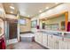 Bright bathroom featuring a walk-in shower, soaking tub, dual sinks, and a large framed mirror at 200 Rachel Ln, Breckenridge, CO 80424
