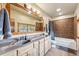 Bathroom with dual sinks, framed mirrors, and walk-in shower at 200 Rachel Ln, Breckenridge, CO 80424