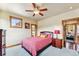 Comfortable bedroom with a ceiling fan, natural light, and wood trim around the windows and doorway at 200 Rachel Ln, Breckenridge, CO 80424