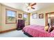 Cozy bedroom with bright windows, dresser, ceiling fan, and warm tones at 200 Rachel Ln, Breckenridge, CO 80424