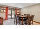 Bright dining room with seating for eight, sliding glass doors to patio, neutral walls and carpet at 200 Rachel Ln, Breckenridge, CO 80424