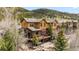 Stunning exterior view of a multi-story home, complemented by a spacious deck and mature trees at 200 Rachel Ln, Breckenridge, CO 80424