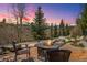 Enjoy outdoor living with a stone patio, fire pit, and mountain views at sunset at 200 Rachel Ln, Breckenridge, CO 80424