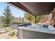 Relaxing hot tub area, sheltered by a roof, with scenic mountain views in the background at 200 Rachel Ln, Breckenridge, CO 80424