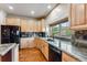 Spacious kitchen includes wood cabinets, granite counters, modern appliances, and a large window at 200 Rachel Ln, Breckenridge, CO 80424