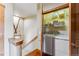 Convenient laundry area with washer, dryer, shelving, and ski storage next to a stairwell at 200 Rachel Ln, Breckenridge, CO 80424