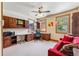Home office with custom wood built-ins, bright windows, and a comfortable red sofa at 200 Rachel Ln, Breckenridge, CO 80424