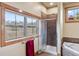 Beautifully tiled shower with a mountain view through the window, plus a soaking tub in the bathroom at 200 Rachel Ln, Breckenridge, CO 80424