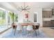 Bright dining room with mid-century modern furniture and large windows at 2456 S Humboldt St, Denver, CO 80210