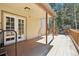 Back porch showing exterior door and wooden railing, surrounded by trees at 10469 Christopher Dr, Conifer, CO 80433